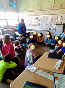 classroom meeting with students sitting in a circle
