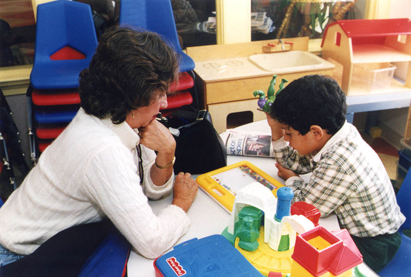 teacher working with a students sketching