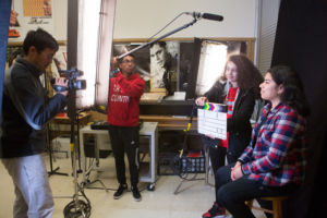 Students filming a scene.