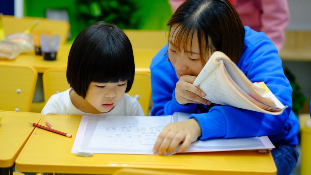 Teacher teaching a student.