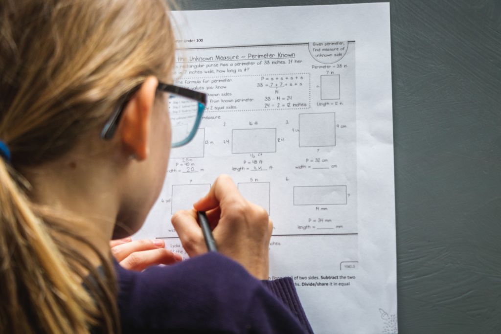 Woman filling out some problems on a worksheet