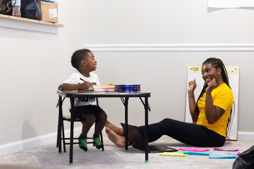 Woman teaching a child.