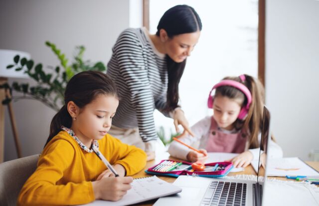 Children doing homework with an adult.