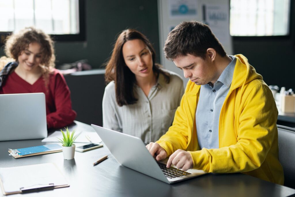 Students using a laptop in class.